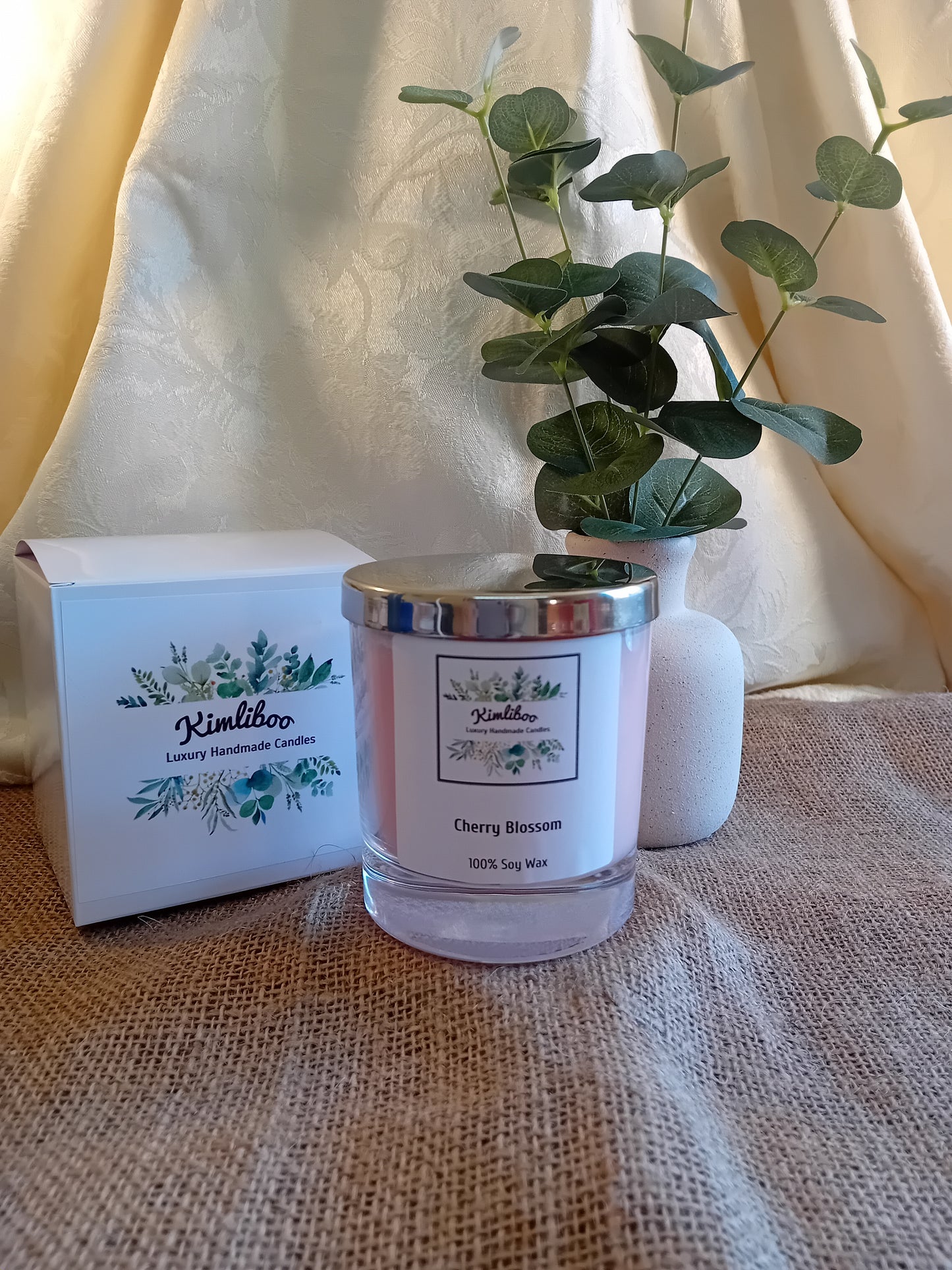 Cherry Blossom fragranced pink candle with silver lid and white presentation box.