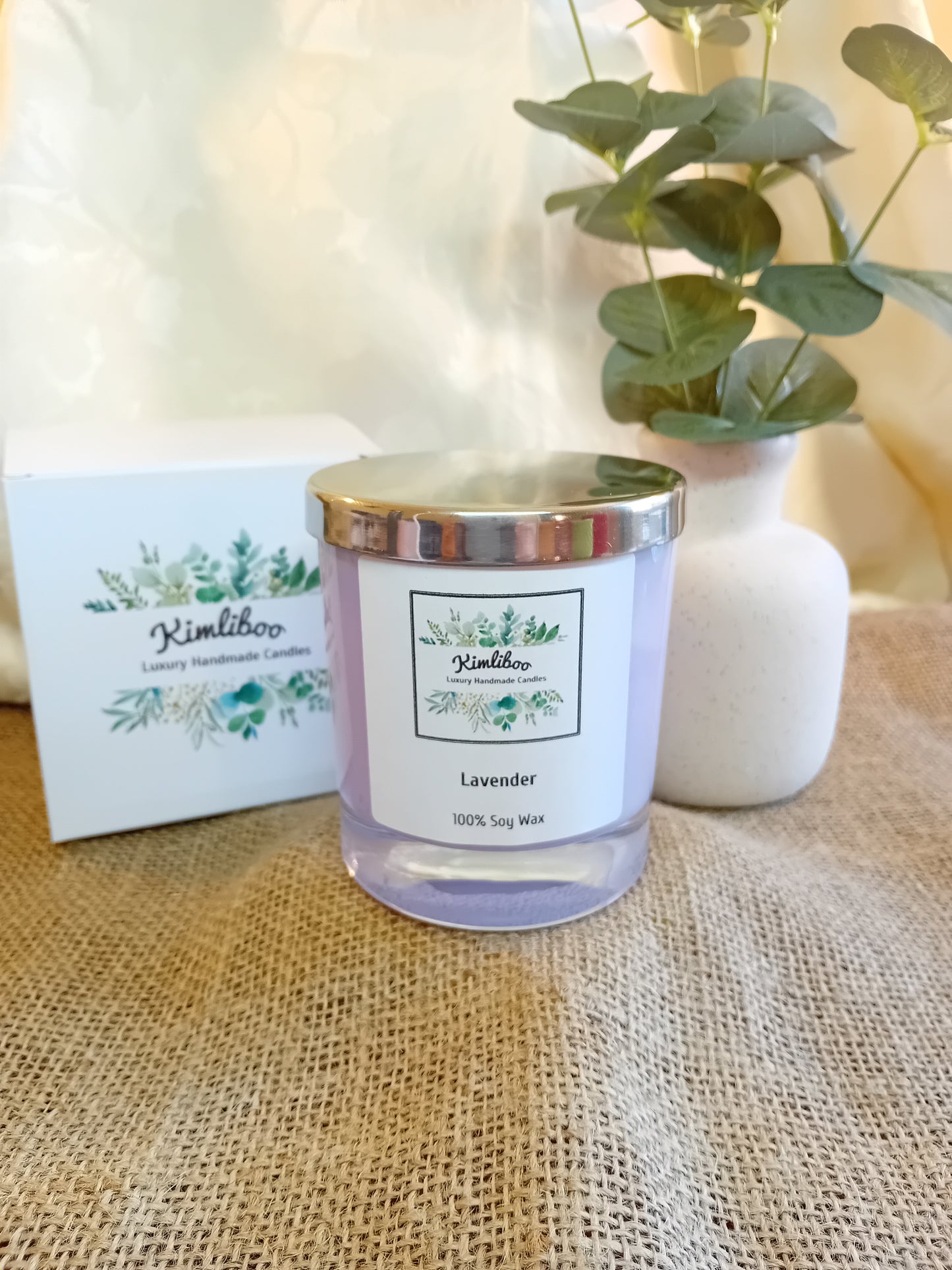 Lavender fragranced lilac candle with silver lid and white presentation box.