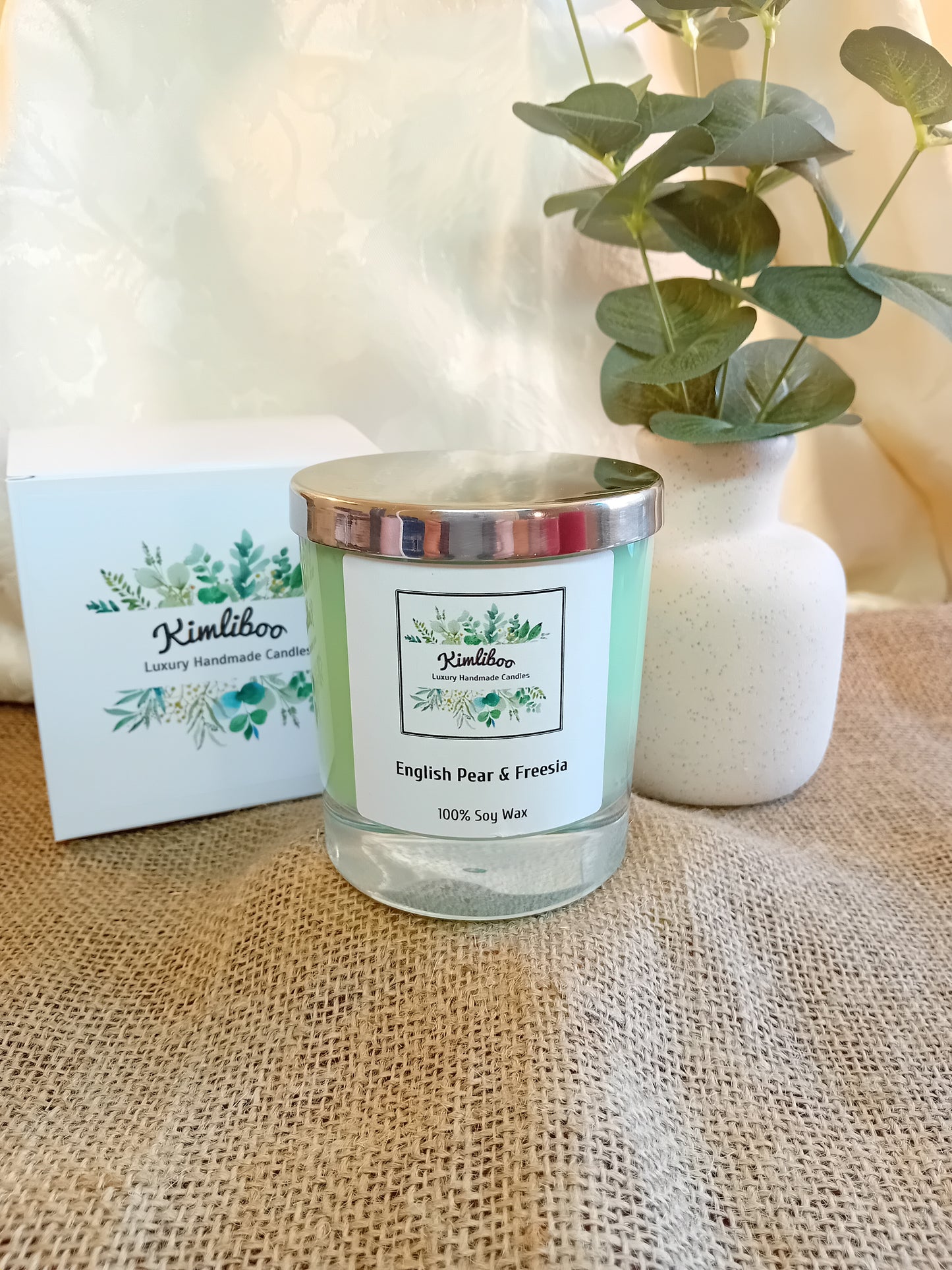 English Pear & Freesia fragranced green candle with silver lid and white presentation box.