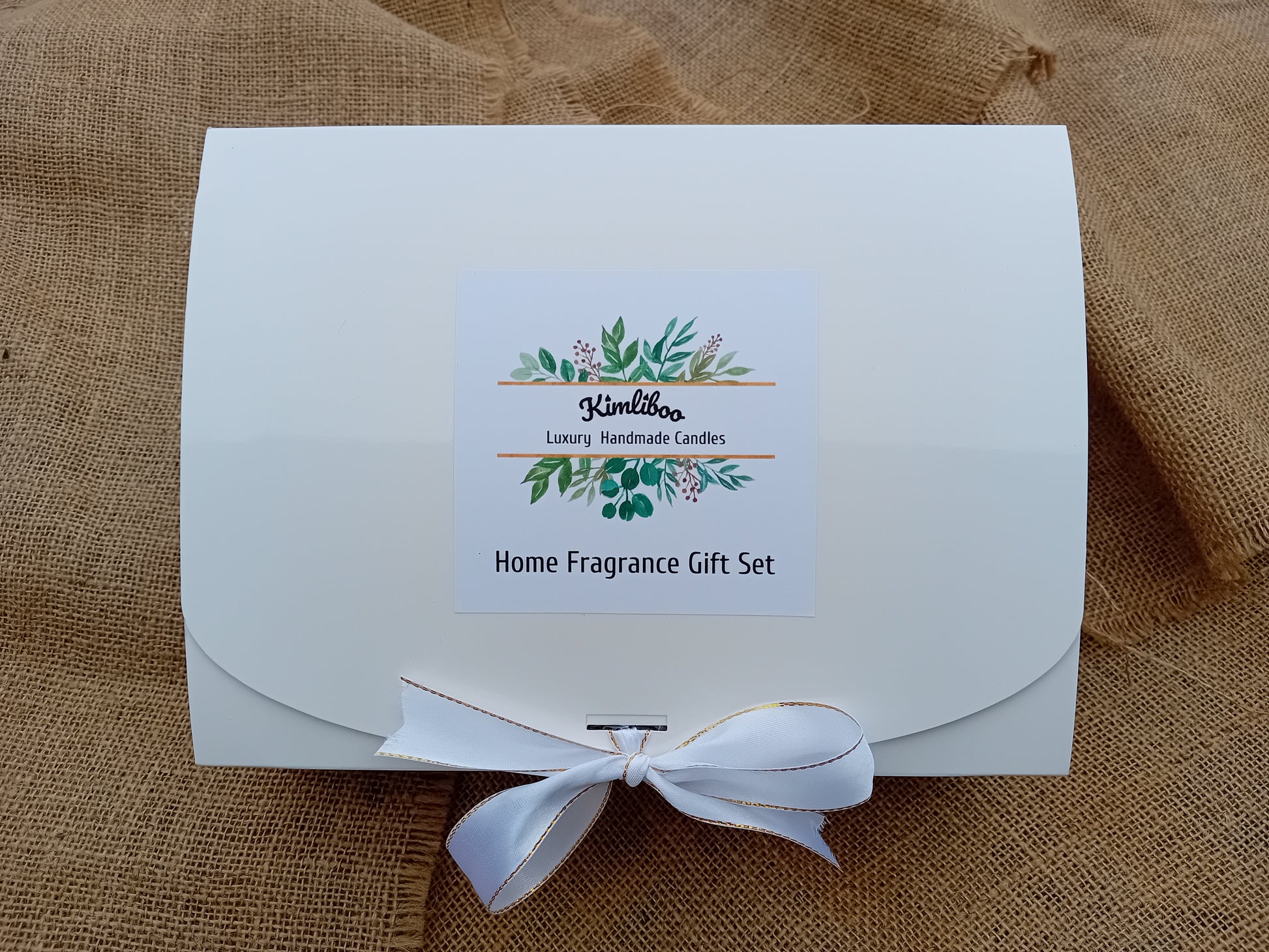 White box with white and gold bow