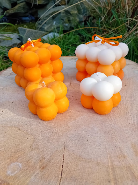 Plain orange and ombre white/orange fragranced Bubble candles - two of them are large, two are mini.  