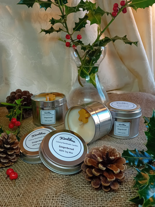 Small silver tin with gingerbread fragranced candle and one gingerbread man wax decoration