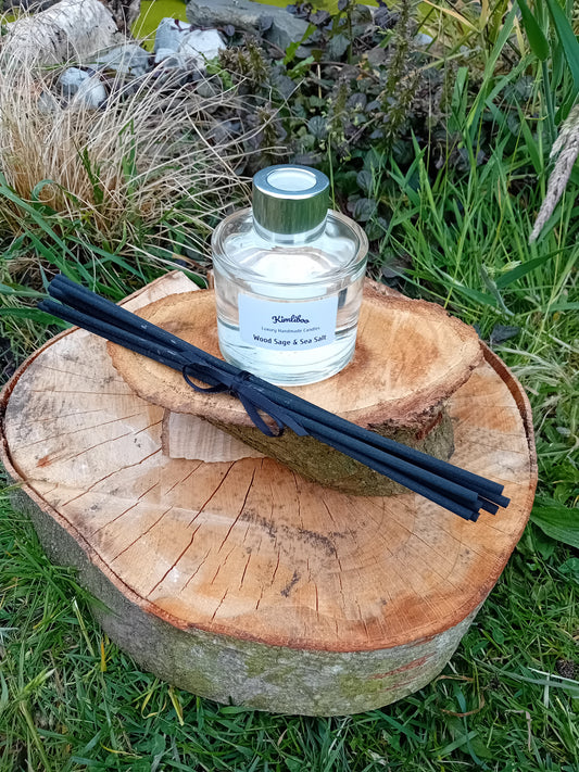 Wood sage & sea salt fragranced reed diffuser in a 100ml circular jar with silver cap and 7 black reeds.